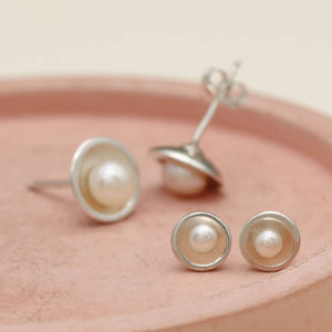 Petite tiny pearl stud earrings shown alongside the Classic sterling silver pearl studs for size comparison