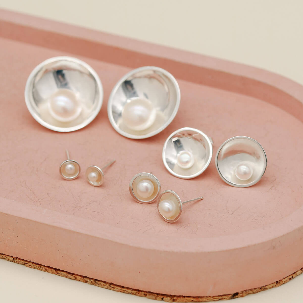Petite, Classic, Signature and Statement sterling silver pearl earrings shown together for size comparison