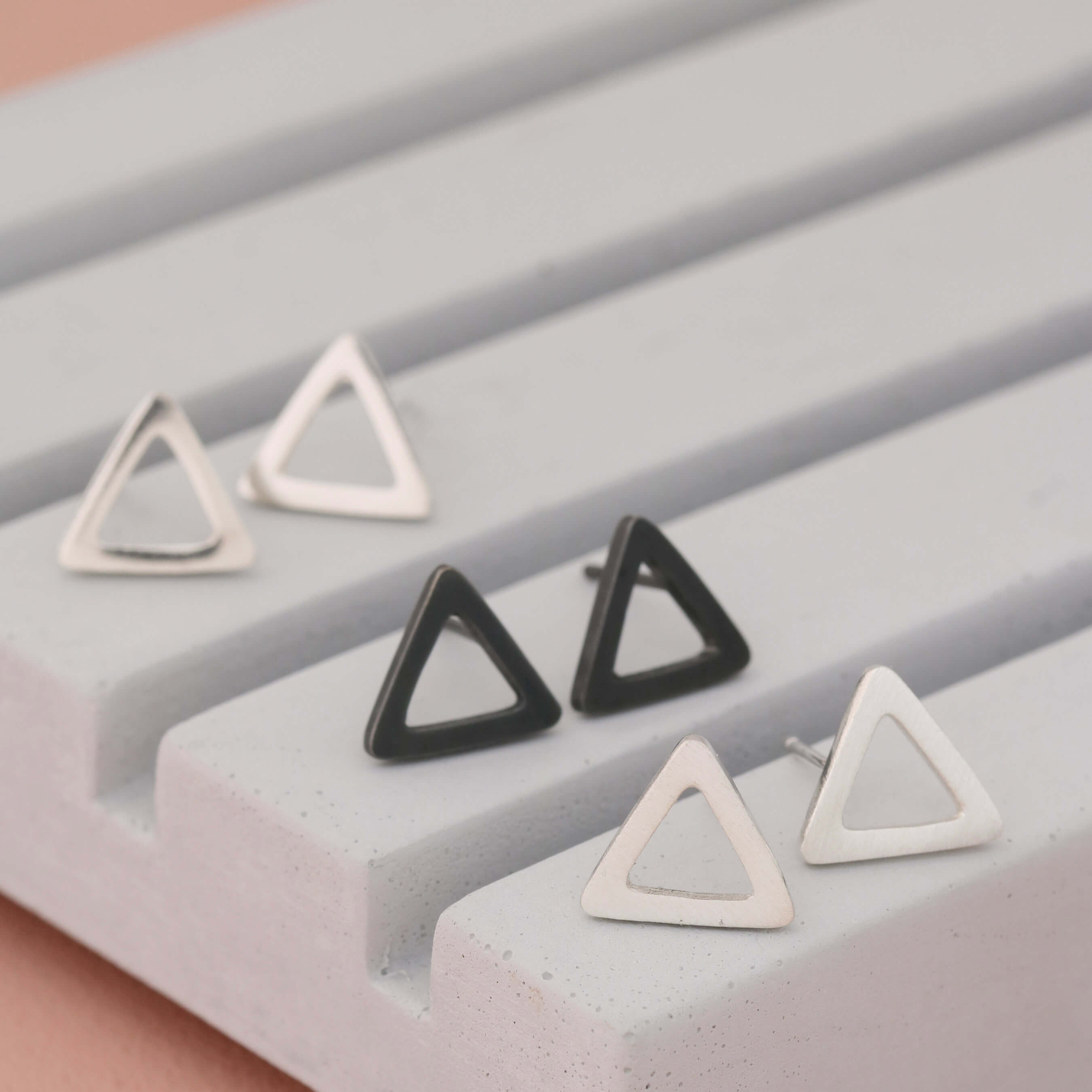 Silver Triangle Earrings in polished, matte and oxidised finishes on grey dish