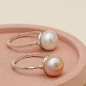 Ivory white and peach pink pearl rings displayed side by side
