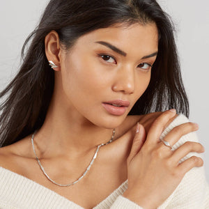 Model wearing a delicate silver link necklace, a sophisticated contemporary necklace that makes a beautiful gift for her on special occasions.