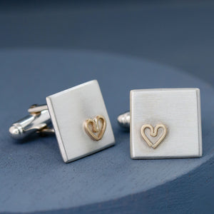 Handmade cufflinks on a deep blue background showing their minimalist design and gold heart accent — thoughtful gift for husband.