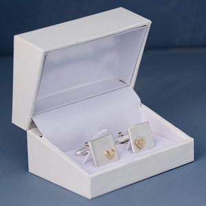 Pair of silver and gold heart cufflinks presented in a white leatherette gift box, ready to give as a thoughtful gift for husband.