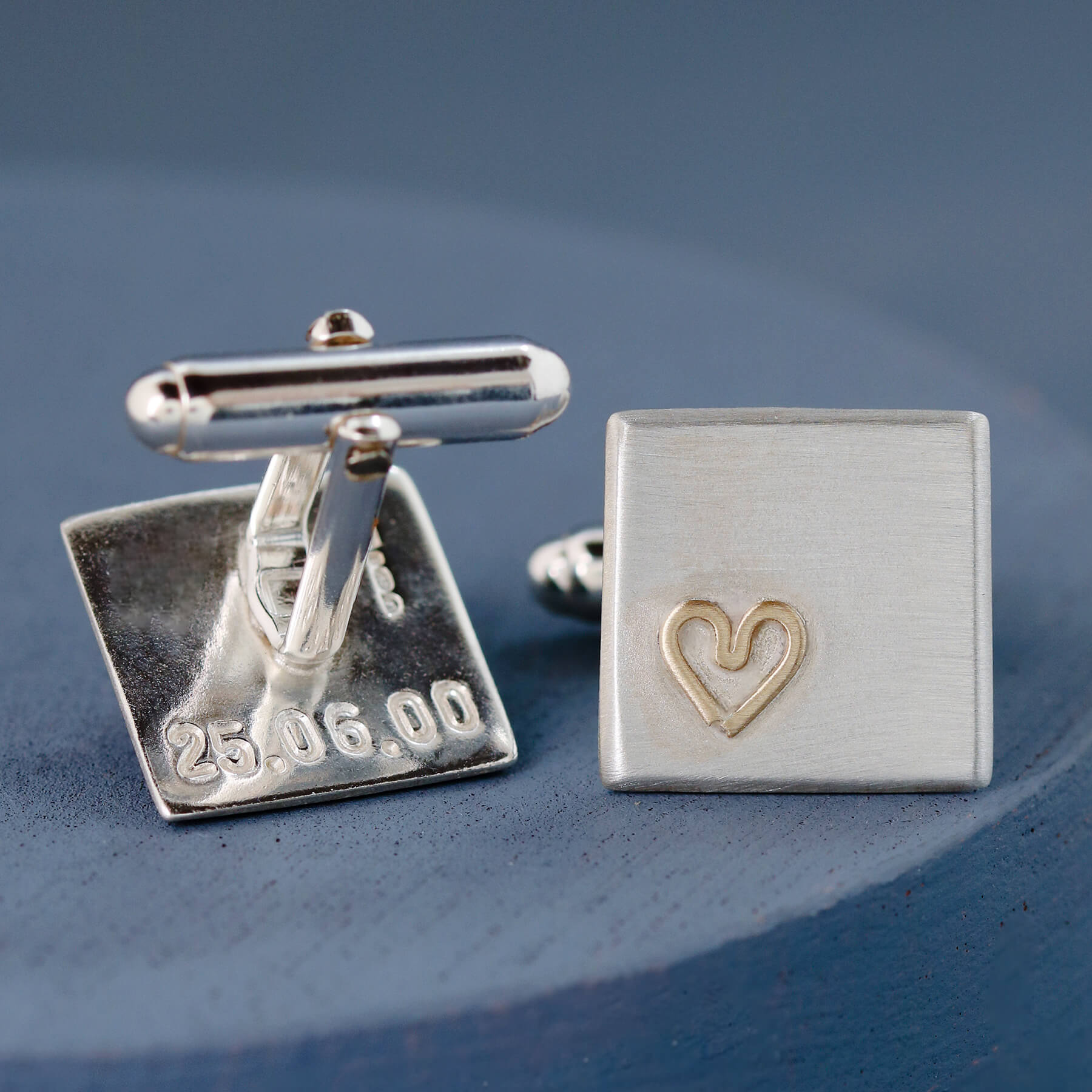 Close-up of one cufflink showing the 9ct gold heart detail and smooth matte silver finish — thoughtful gift for husband.