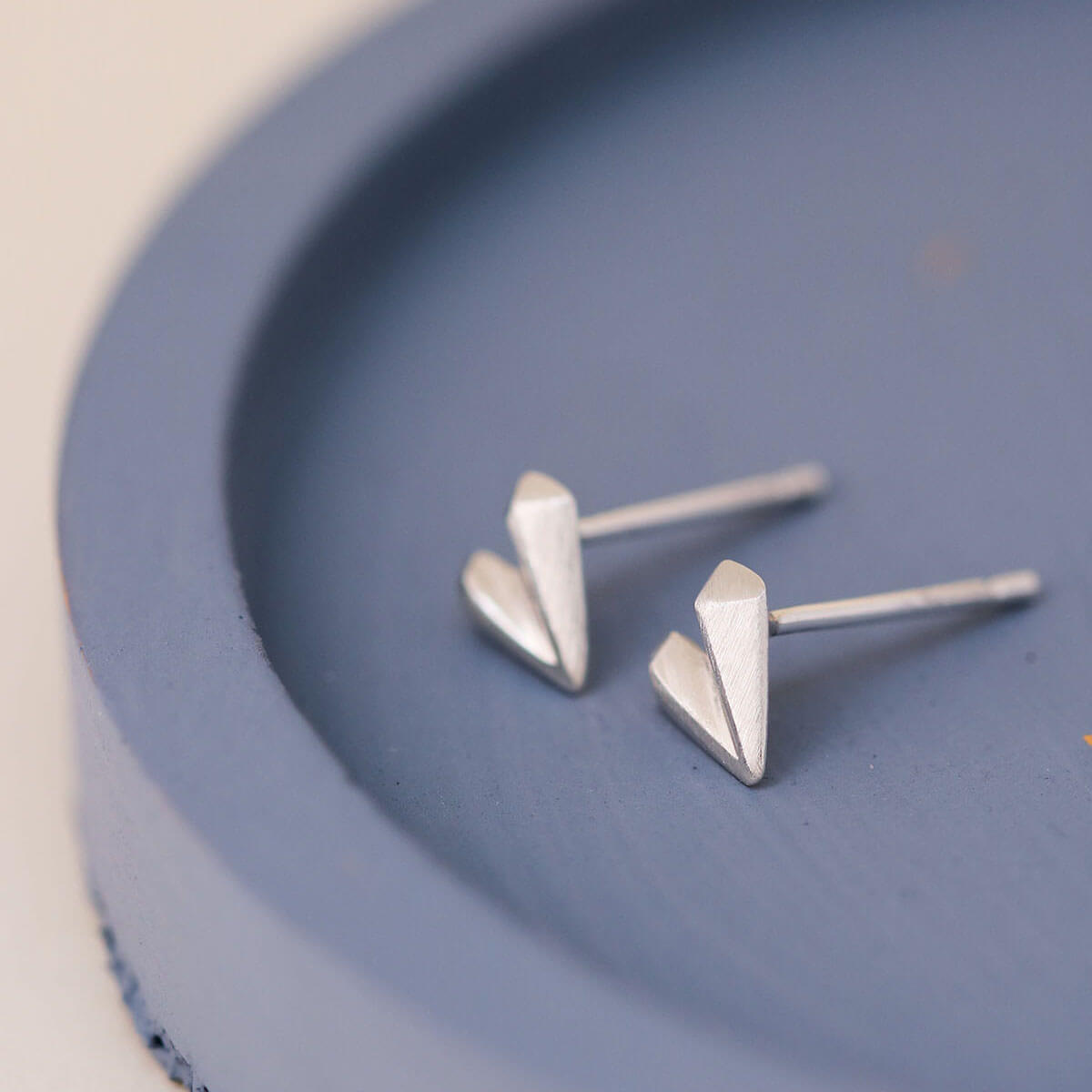 Silver heart stud earrings on blue dish, love heart earrings perfect Valentine’s Day gift for her