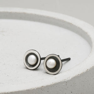 Close-up of Petite Tiny Pearl Stud Earrings featuring handcrafted oxidised sterling silver and genuine 3mm freshwater pearls.