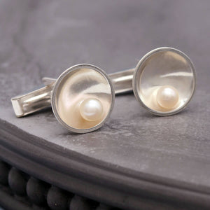 Detailed view of pearl cufflinks for men highlighting the lustre of freshwater pearls and polished silver finish.