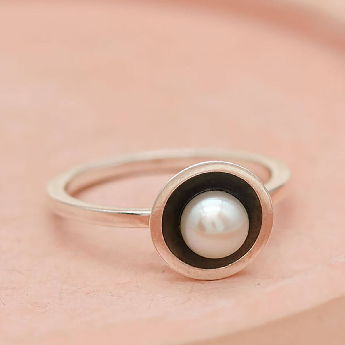 Oxidised silver stackable pearl ring worn alongside other stacking rings