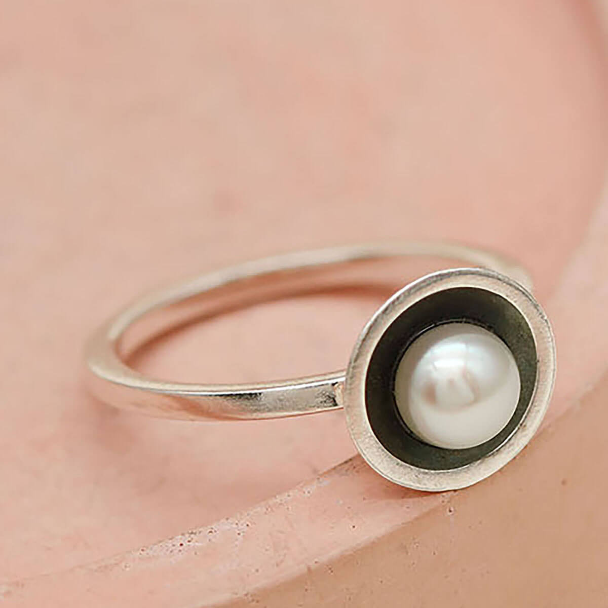 Side profile of an oxidised silver pearl ring handcrafted in sterling silver