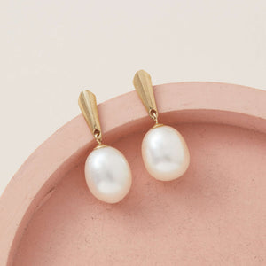 9ct gold pearl earrings displayed on pink ceramic dish emphasising lustrous pearls – perfect gold bridal earrings gift idea
