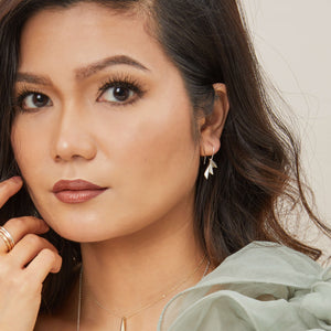 Fan drop earrings shown on model in natural light, displaying the sculptural art deco design; ideal luxury jewellery gift for any occasion.