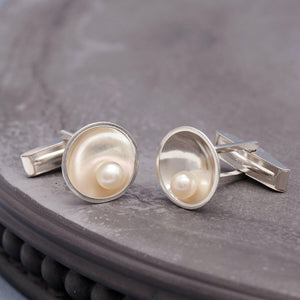 Men's pearl cufflinks in solid sterling silver displayed on a dark grey background.