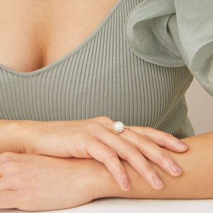 Model wearing a sterling silver large pearl ring with ivory white pearl