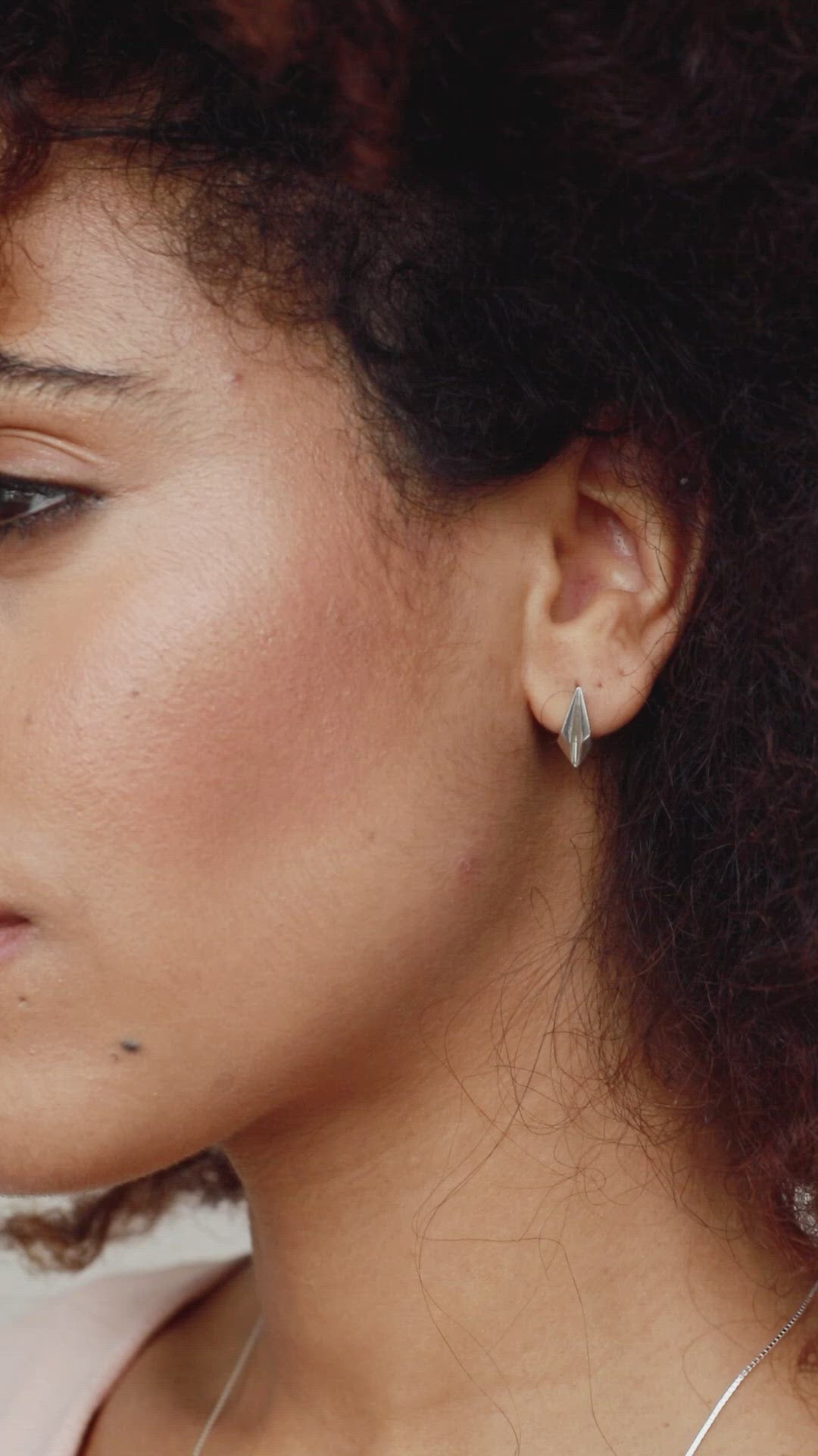 Video of a model wearing silver art deco earrings, showing how the art deco earrings studs sit on the ear with oxidised detail, ideal for bridal jewellery, bridesmaid gifts, or birthday gifting.