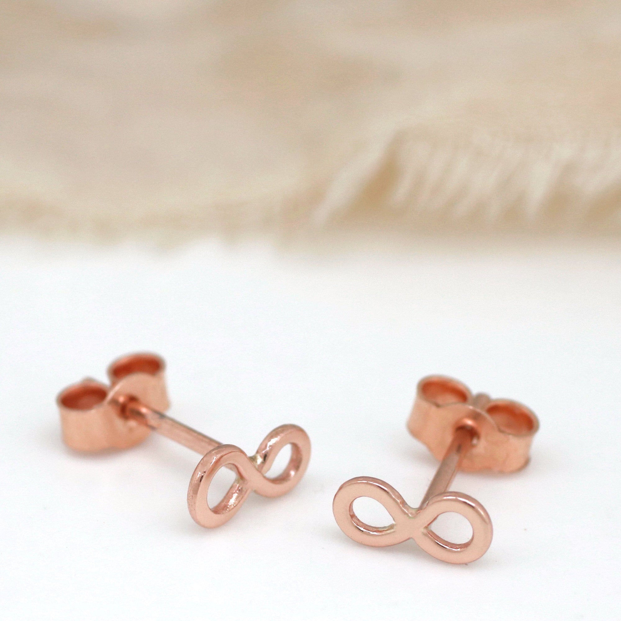 Rose gold infinity stud earrings