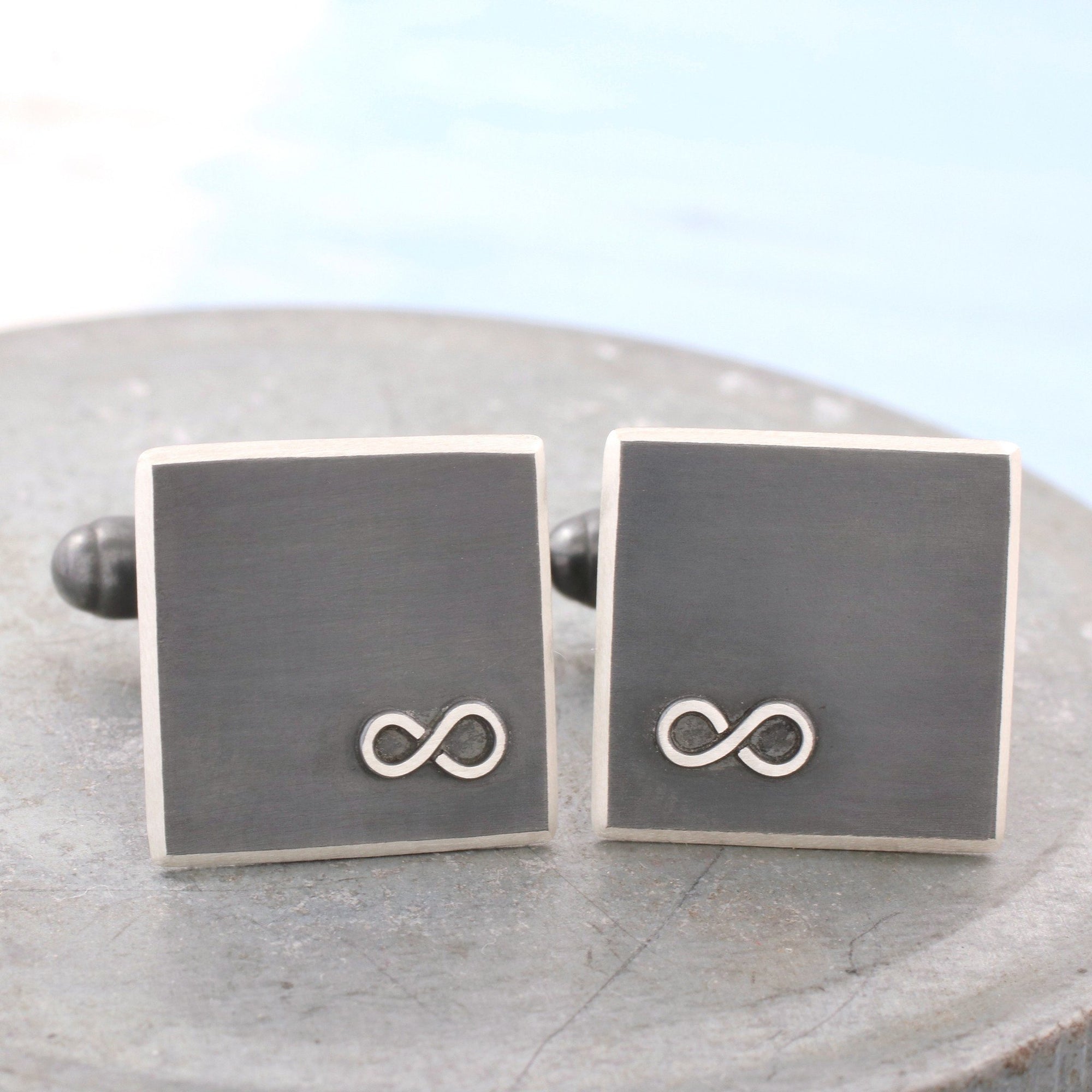 silver and black infinity cufflinks