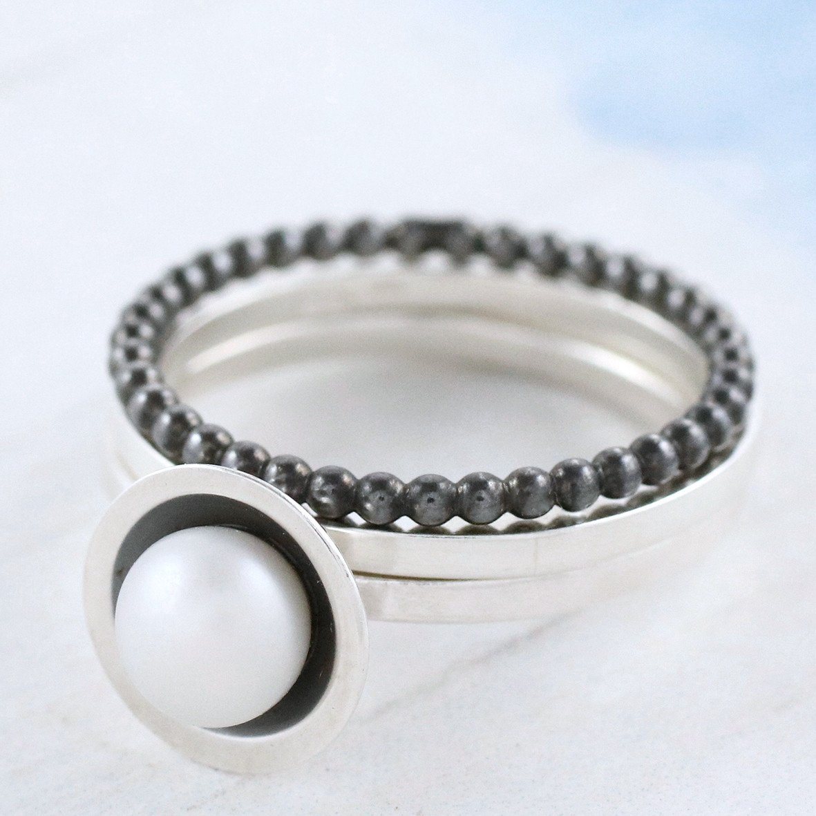 silver and black pearl stacking rings